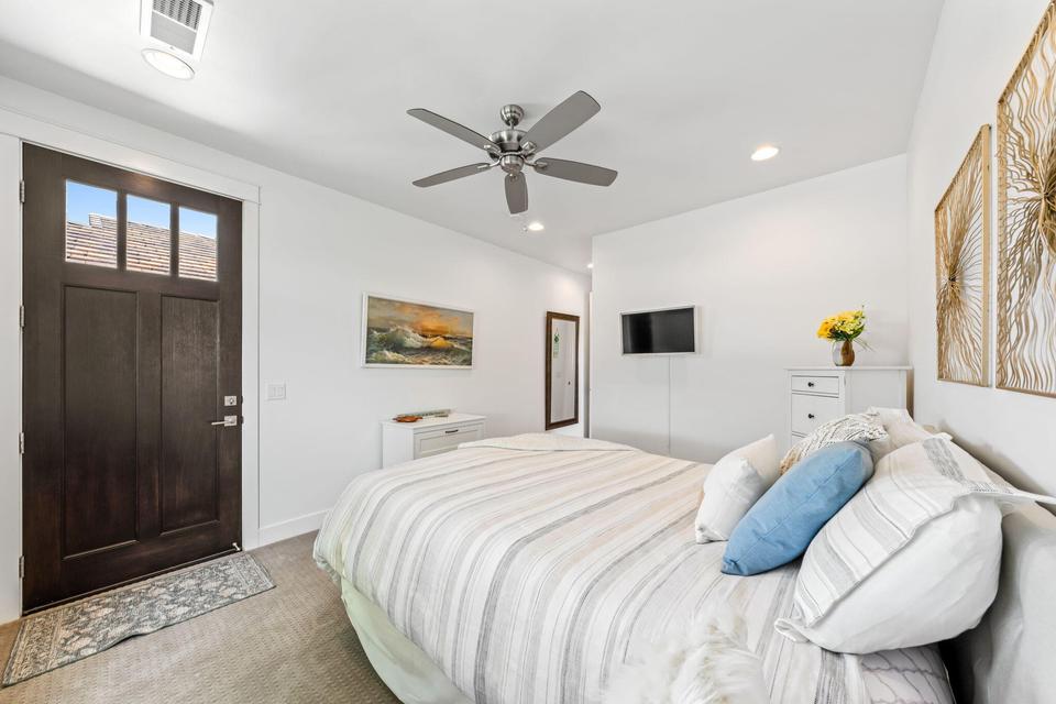 Bedroom with light carpet, ceiling fan, and recessed lighting