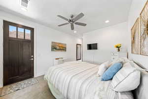 Bedroom with light carpet, ceiling fan, and recessed lighting