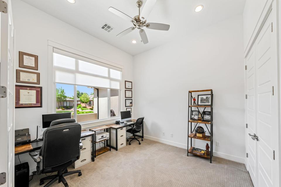 Office area with ceiling fan, light colored carpet, and recessed lighting