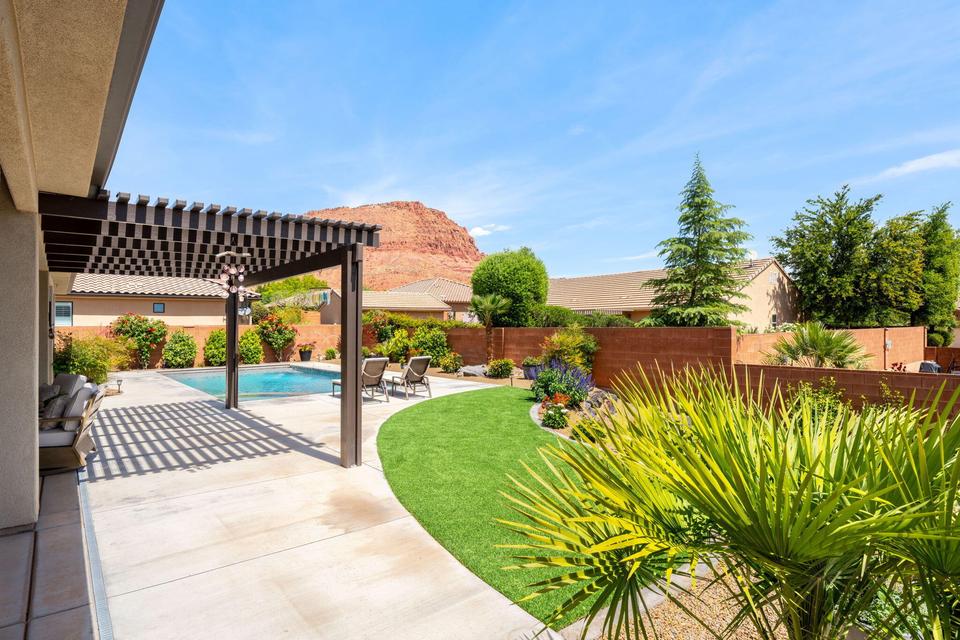 Fenced backyard with a pergola and a patio