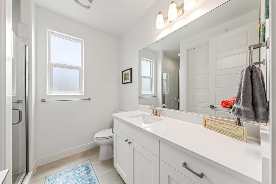 Bathroom with vanity, a shower stall, and light tile patterned flooring