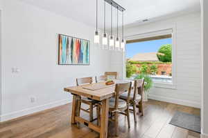 Dining space featuring hardwood / wood-style flooring and baseboards