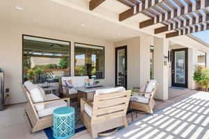View of patio with an outdoor living space and a pergola