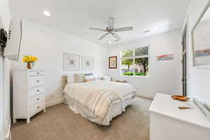 Bedroom featuring light carpet, a ceiling fan, and recessed lighting