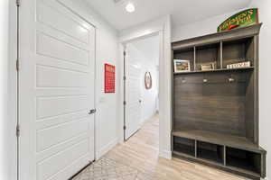 Mudroom with recessed lighting and light wood finished floors
