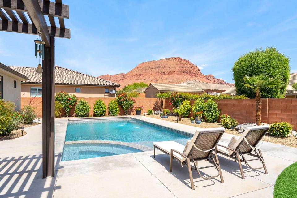 Combined pool / hot tub featuring a patio area, a pergola, a fenced backyard, and a mountain view