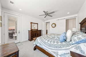 Bedroom with a barn door, light carpet, ceiling fan, access to exterior, and recessed lighting