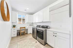 Laundry area with independent washer and dryer, cabinet space, and an office area