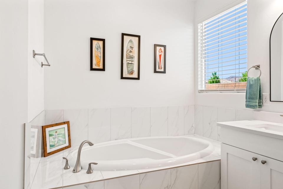 Full bath with a garden tub and vanity