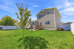 Back of property with a fenced backyard and a gate