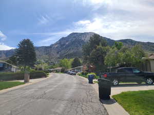View of asphalt road featuring a mountain view and a residential view