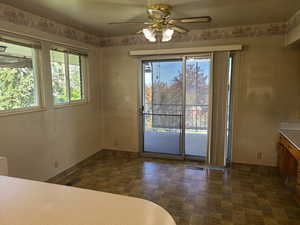 Unfurnished dining area with ceiling fan