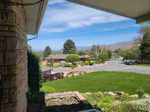 View of green lawn featuring a mountain view and a residential view