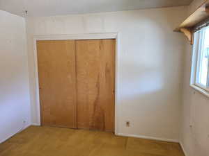 Unfurnished bedroom featuring a textured ceiling, a closet, and carpet floors