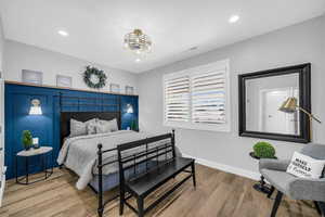 Bedroom with wood finished floors and recessed lighting