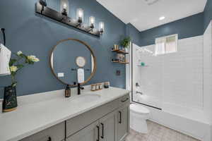 Bathroom featuring vanity and shower / washtub combination