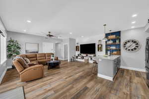 Living room with ceiling fan, wood finished floors, and recessed lighting