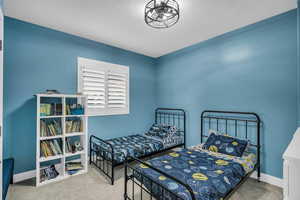 Bedroom with light colored carpet