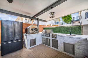 View of patio with a sink and area for grilling