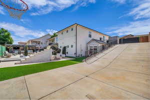 Back of property with a patio and stucco siding