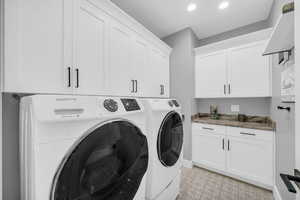 Laundry room with washer and dryer and cabinet space