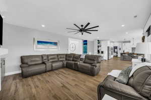 Living room featuring a ceiling fan, wood finished floors, and recessed lighting