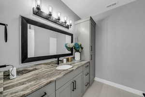 Bathroom with vanity and baseboards