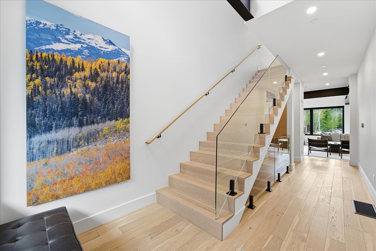 Staircase featuring wood-type flooring and recessed lighting