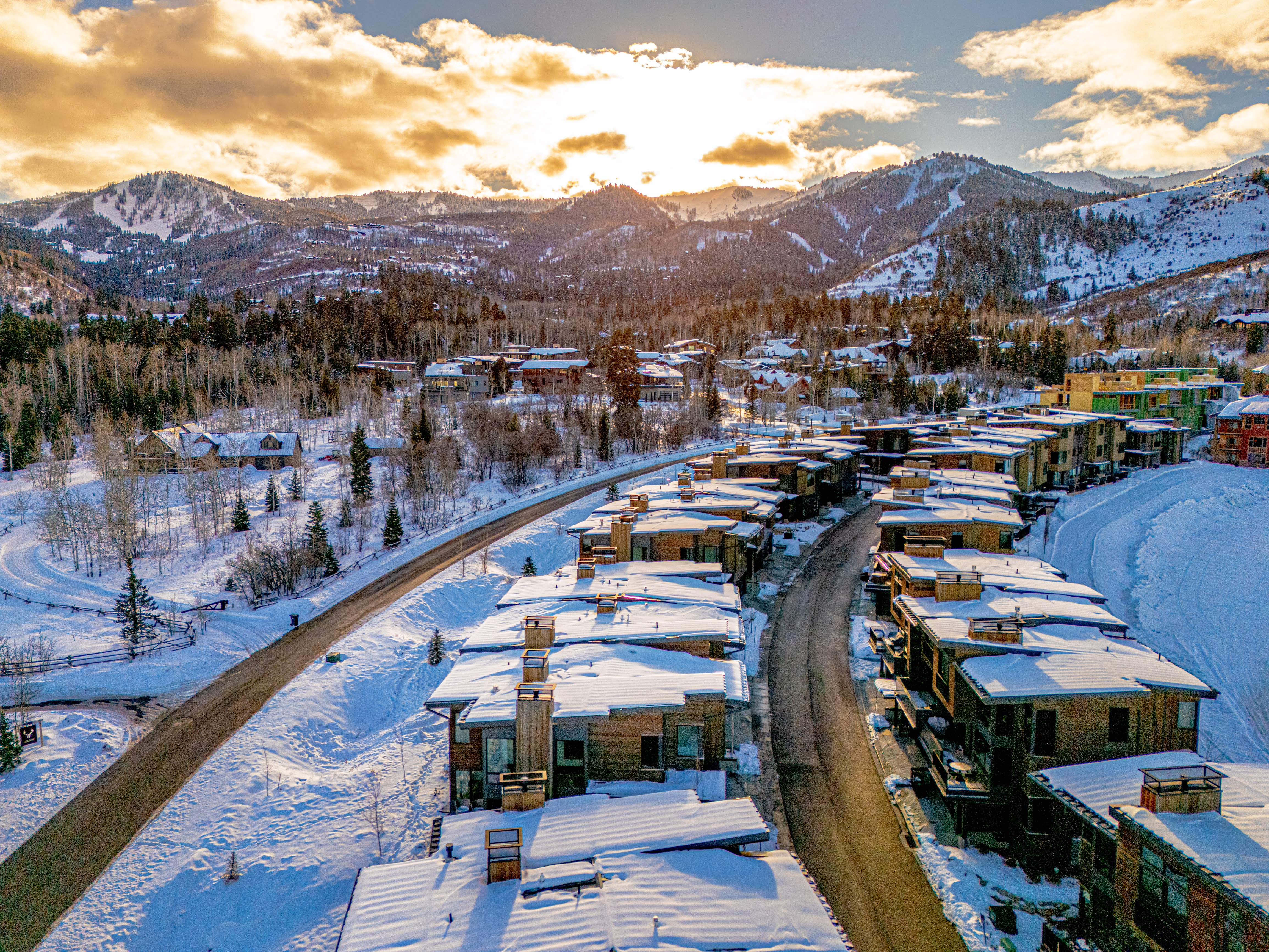 Snowy aerial view featuring a mountain view and a residential view