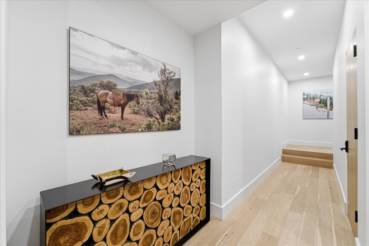 Hall featuring light wood-style floors, recessed lighting, and a mountain view