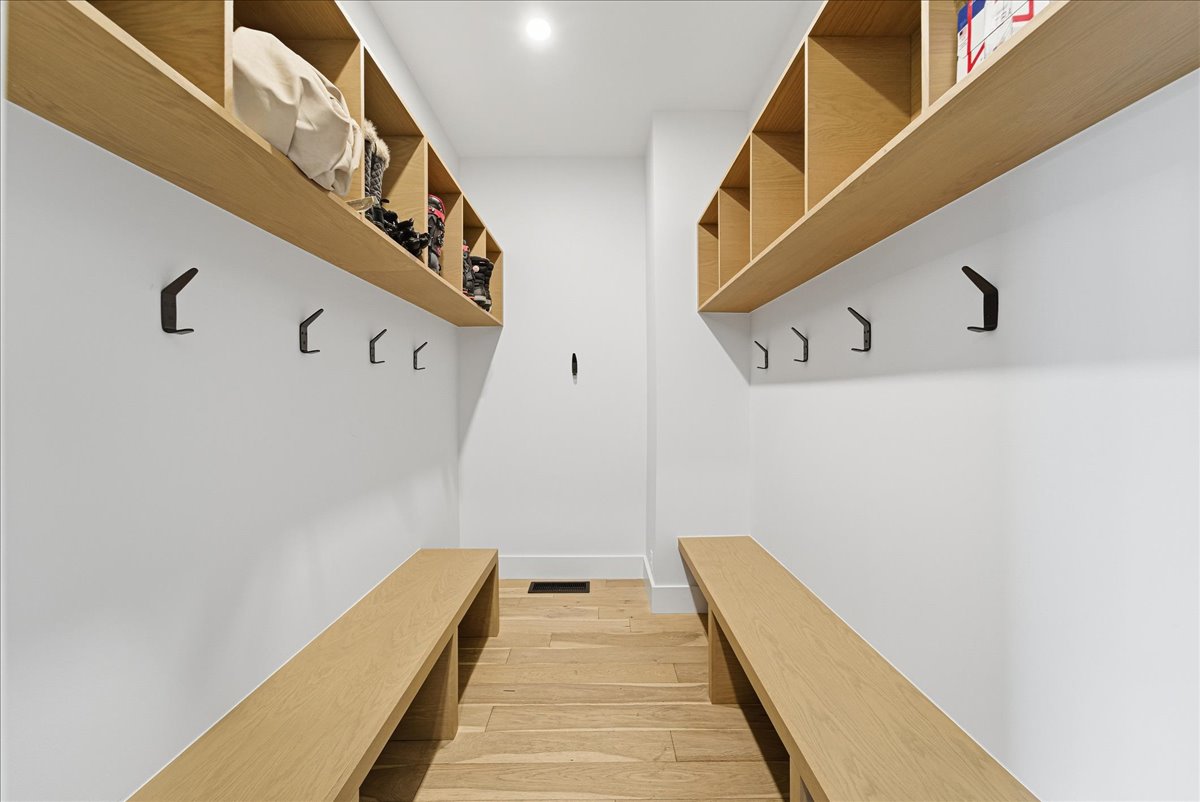 Mudroom featuring light wood finished floors and baseboards