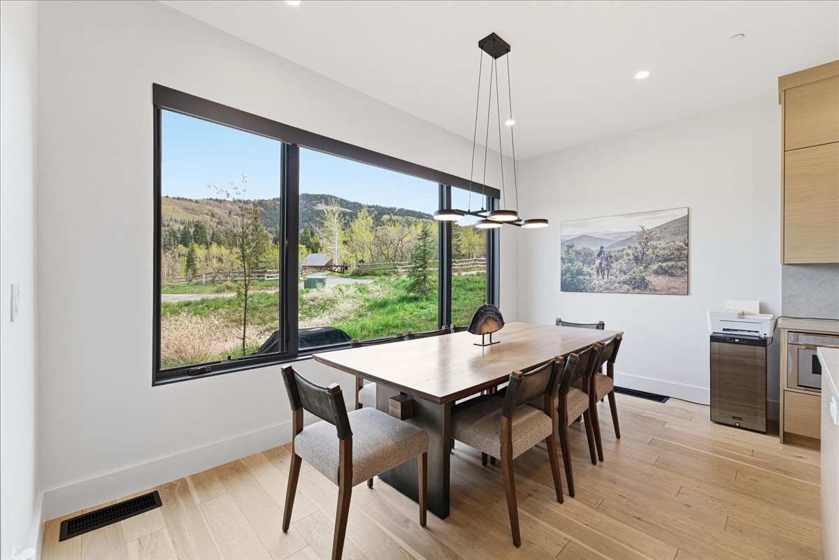 Dining area with light wood-style flooring, a mountain view, and recessed lighting