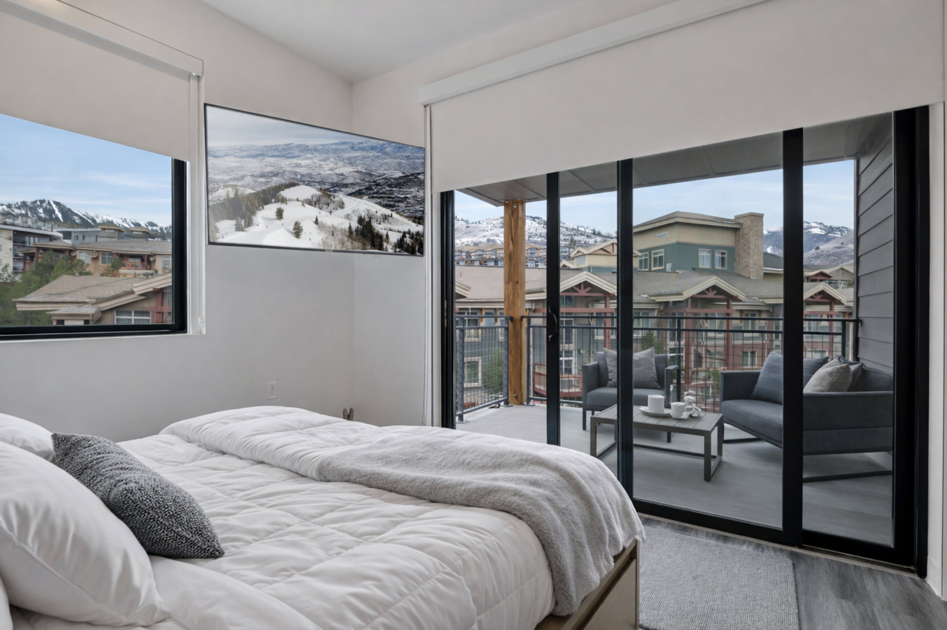 Bedroom featuring a mountain view, access to exterior, and wood finished floors
