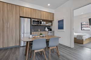 Dining area featuring dark wood-style floors and recessed lighting