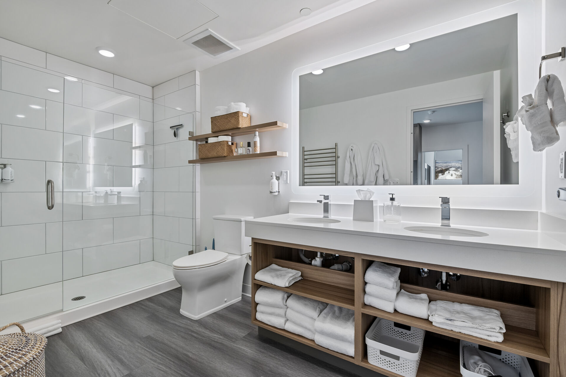 Bathroom with double vanity, a stall shower, dark wood-style flooring, and recessed lighting