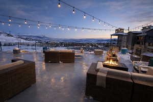 Patio terrace at dusk with a patio area and an outdoor living space with a fire pit