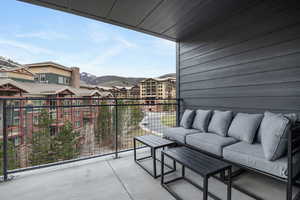 Balcony featuring a mountain view and outdoor seating