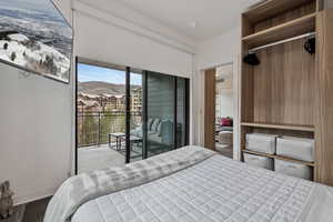 Bedroom featuring a mountain view, access to outside, and a closet
