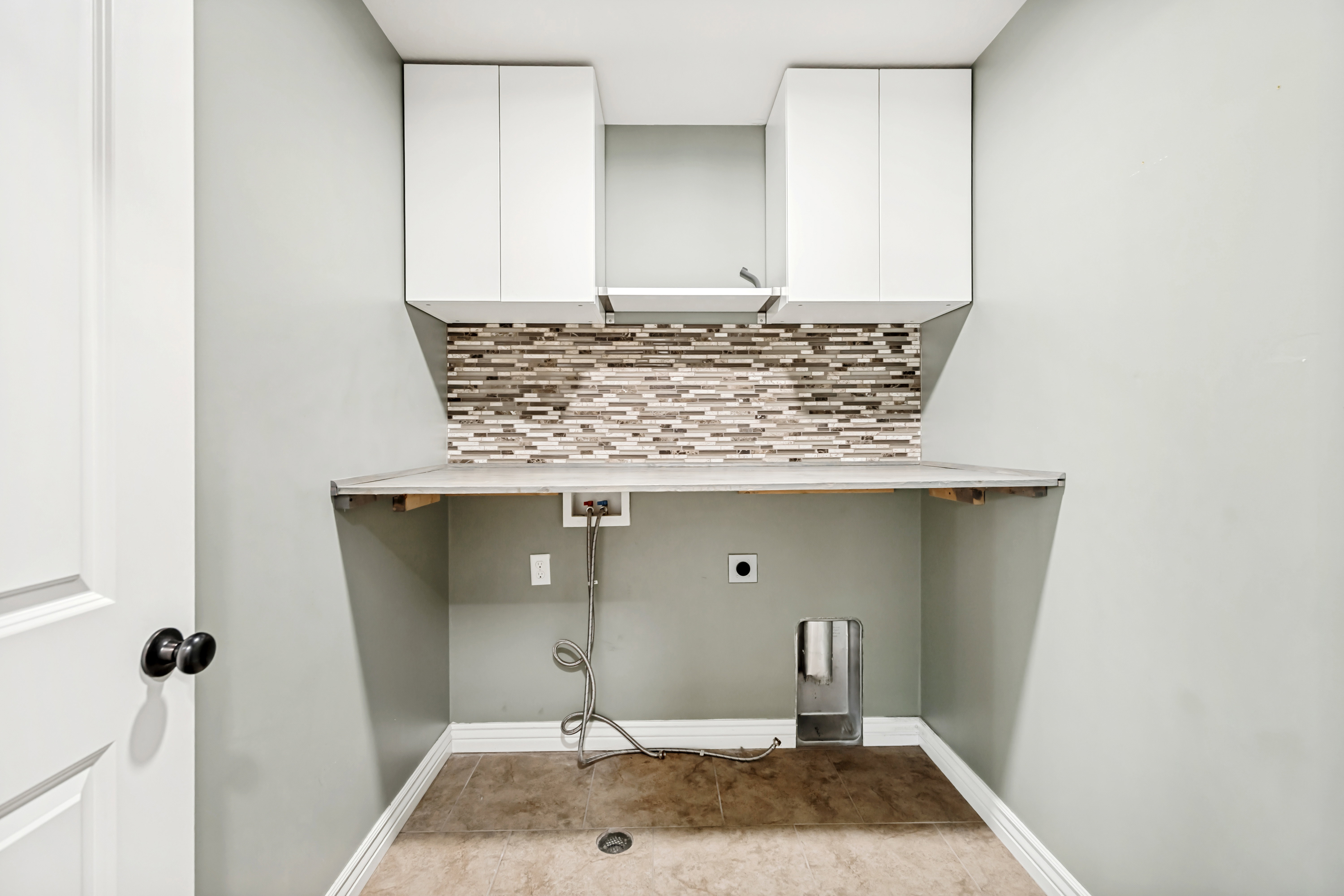 Laundry room with washer hookup, hookup for an electric dryer, and cabinet space