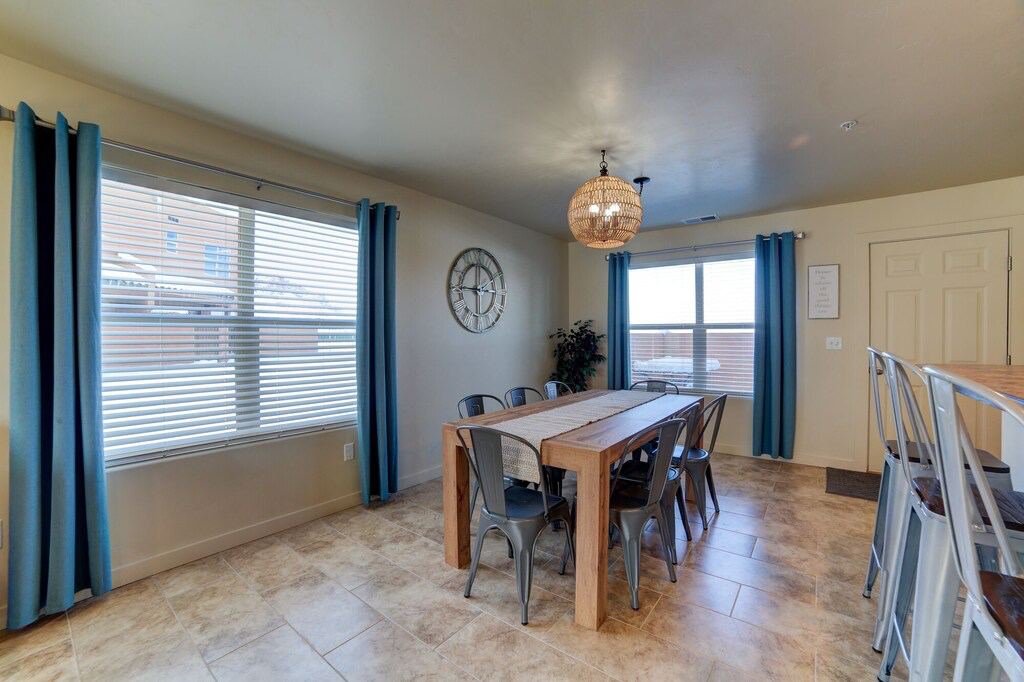 Dining space featuring light tile patterned floors and suspended lighting