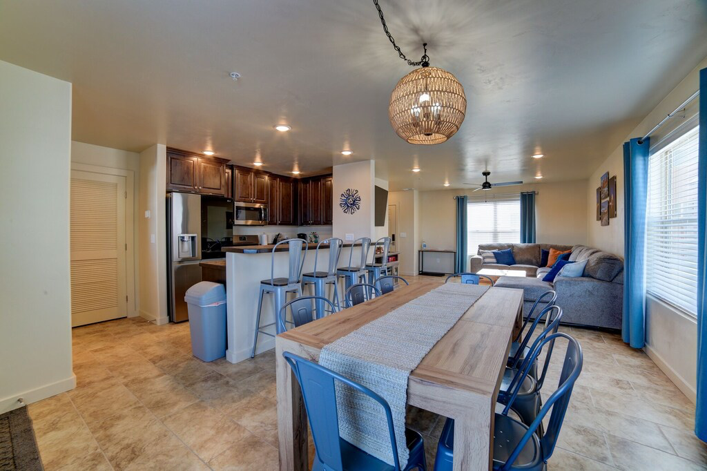 Dining area with suspended lighting and a ceiling fan