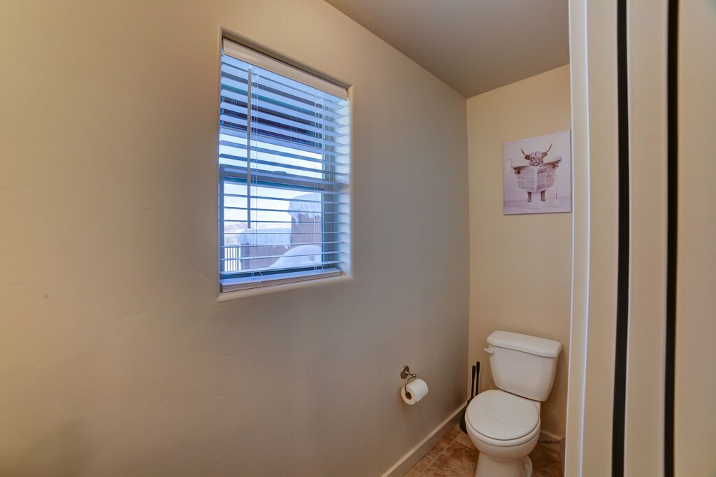 Bathroom featuring toilet and baseboards