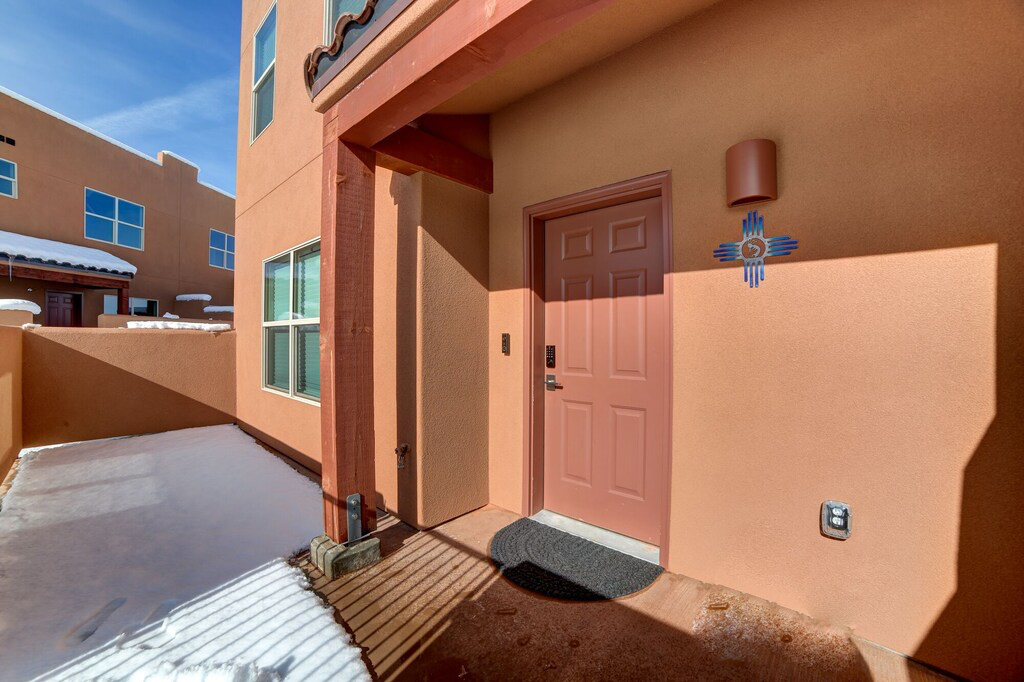 Entrance to property featuring stucco siding