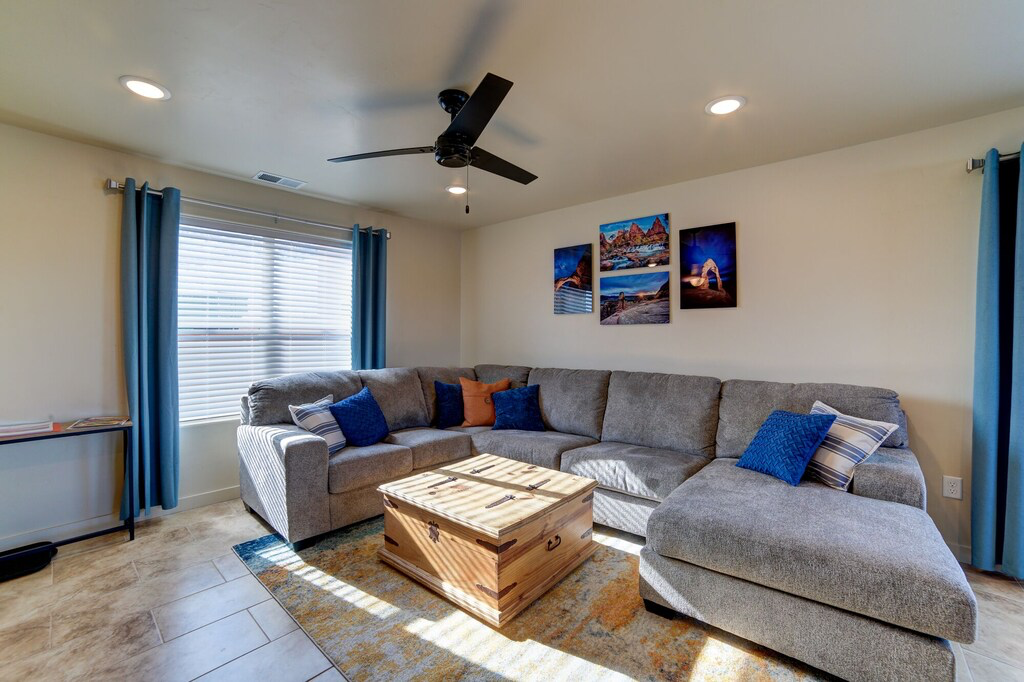 Living room with a ceiling fan and recessed lighting