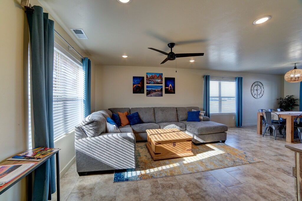 Living area with a ceiling fan and recessed lighting