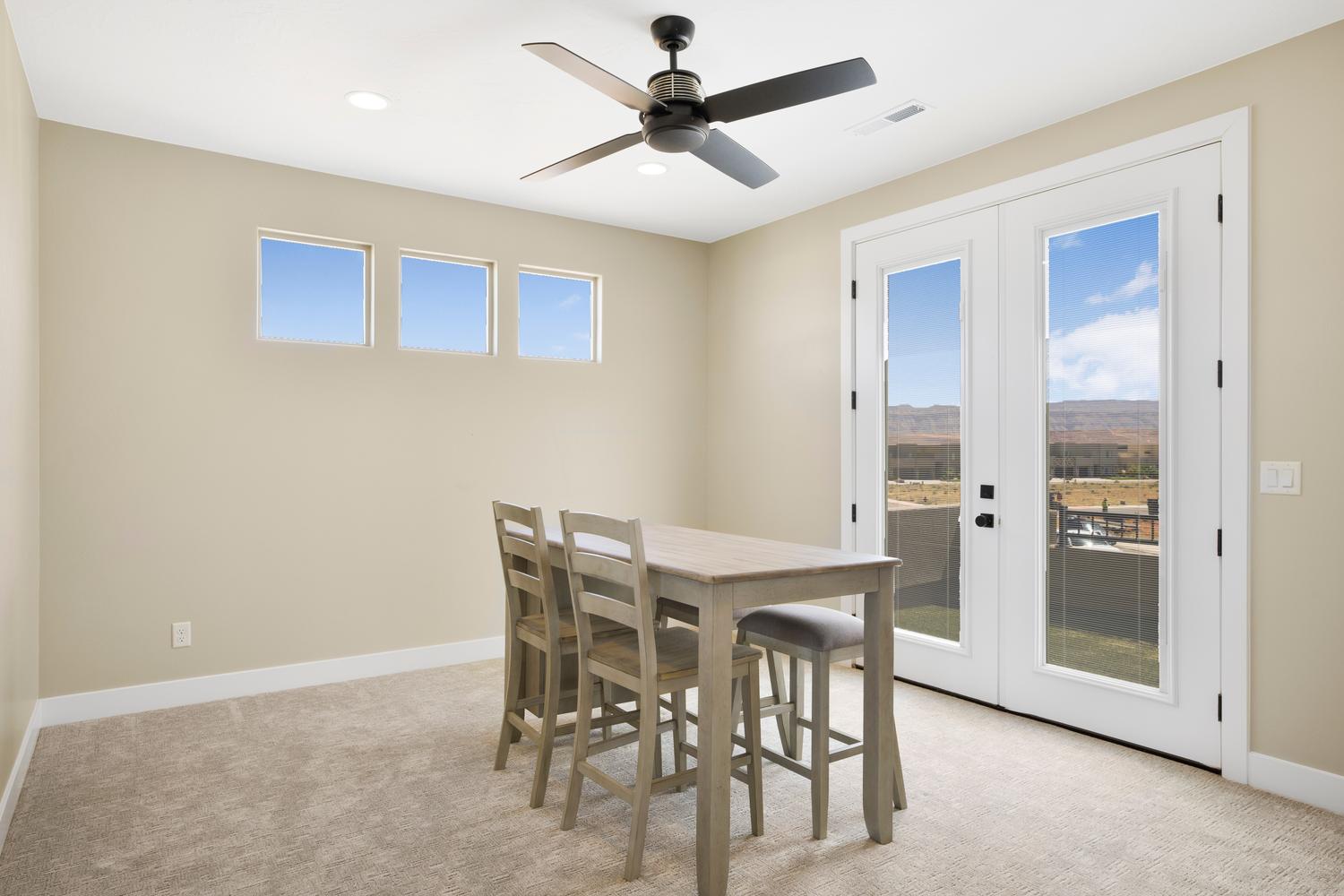 Dining room featuring french doors, light colored carpet, a ceiling fan, and recessed lighting