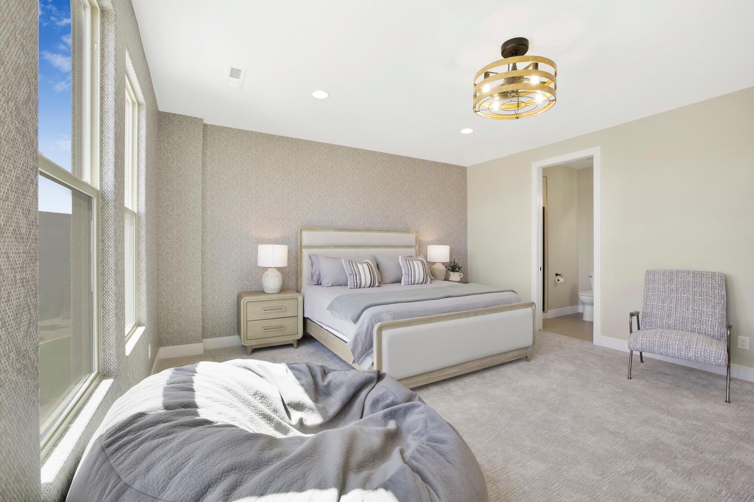 Carpeted bedroom featuring wallpapered walls, recessed lighting, ensuite bathroom, and an accent wall