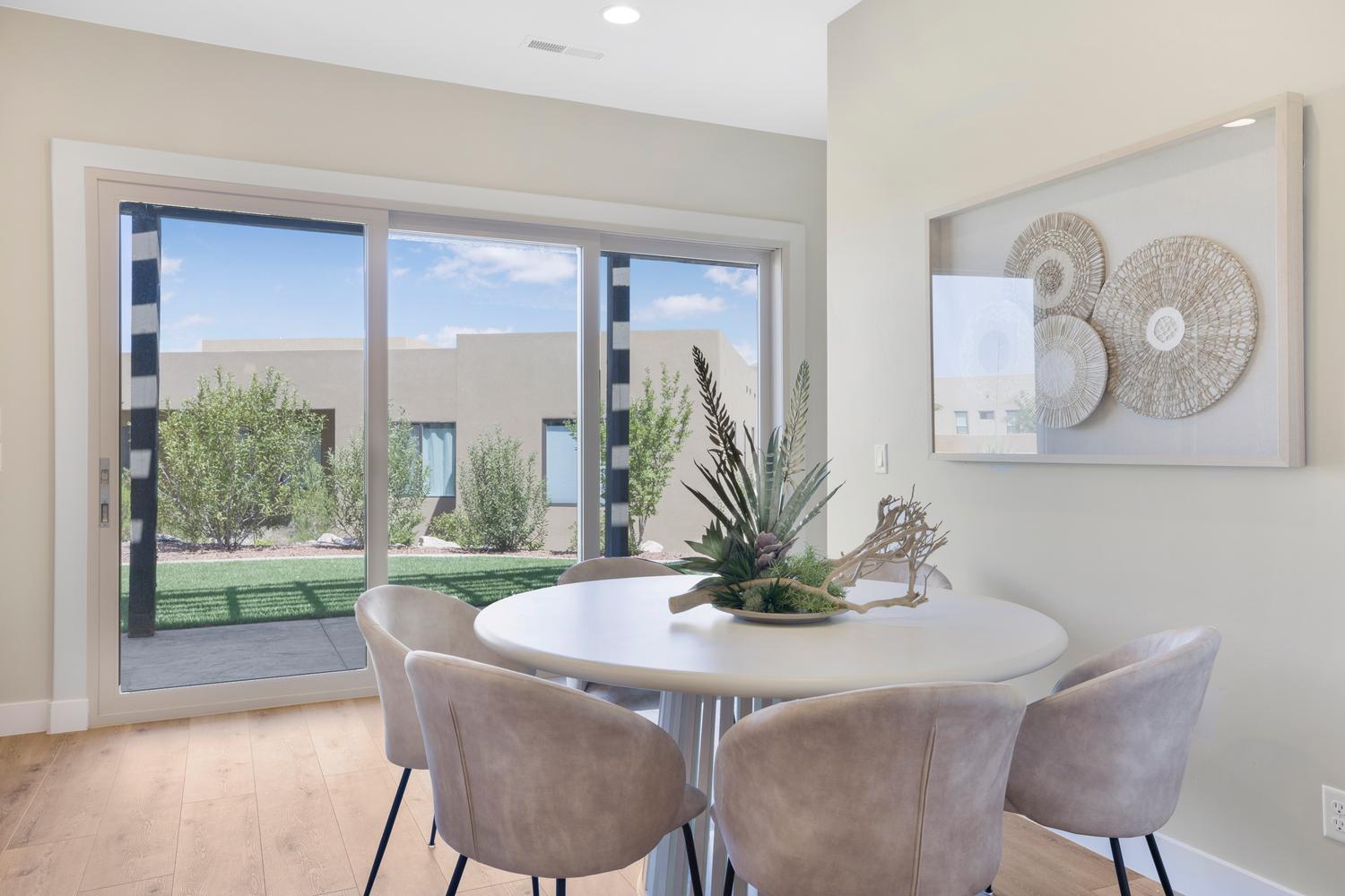 Dining space with light wood-style floors and recessed lighting