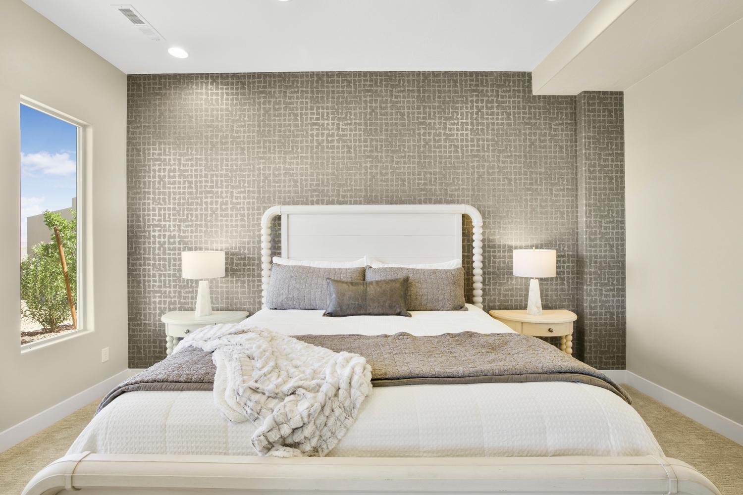 Bedroom featuring light colored carpet, an accent wall, recessed lighting, and tile walls