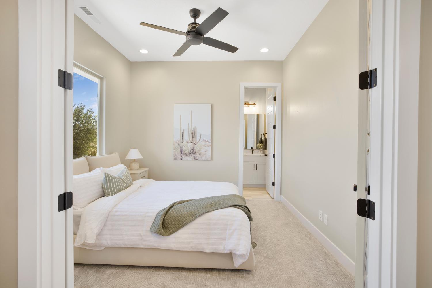 Bedroom with light colored carpet, recessed lighting, and a ceiling fan